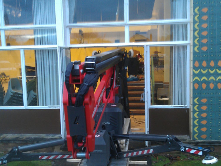 Sophie tracked spiderlift cherrypickers from High Reaching Solutions going up a ramp and through a narrow door for internal building inspection Malton York North Yorkshire