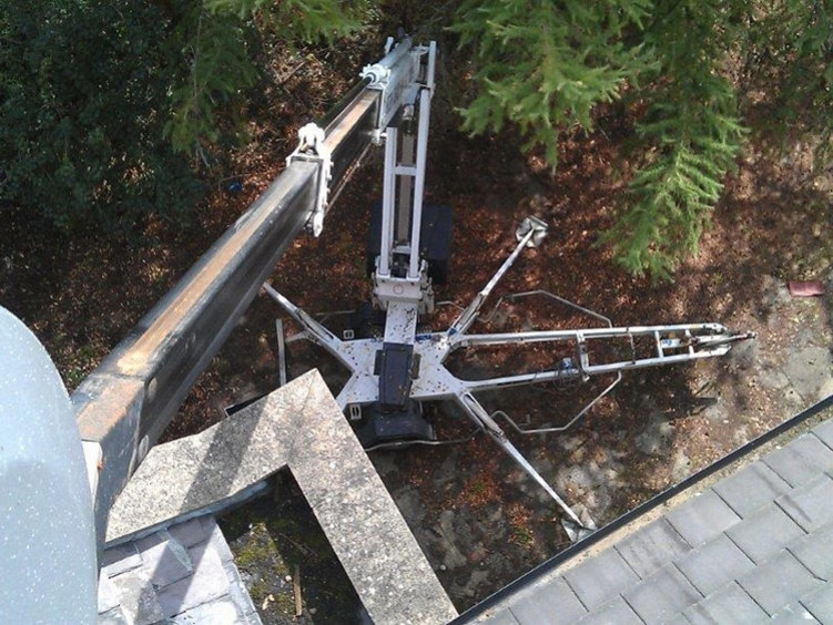 Delila, High Reaching Solutions road towable 16m Trailer mounted access platform, looking down from basket whilst carrying out roof and building maintenance in York, North Yorkshire.