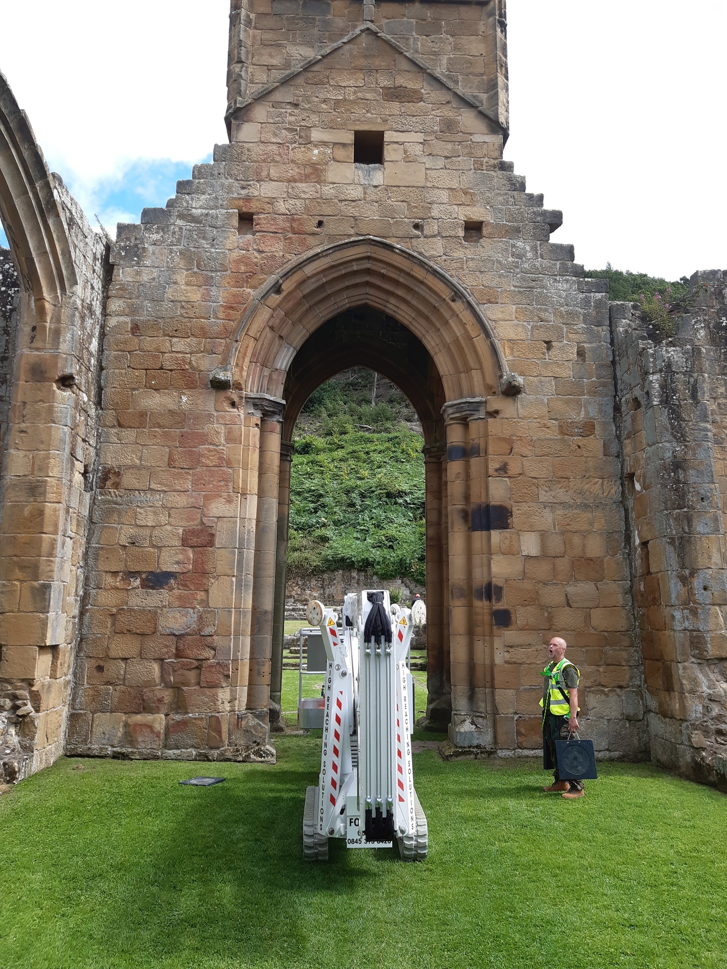 Lottie, High Reaching Solutions 20m Lithium hybrid tracked spiderlift cherrypicker assisting with a Stone Survey after going through an archway at a ruined abbey near Northallerton, North Yorkshire.