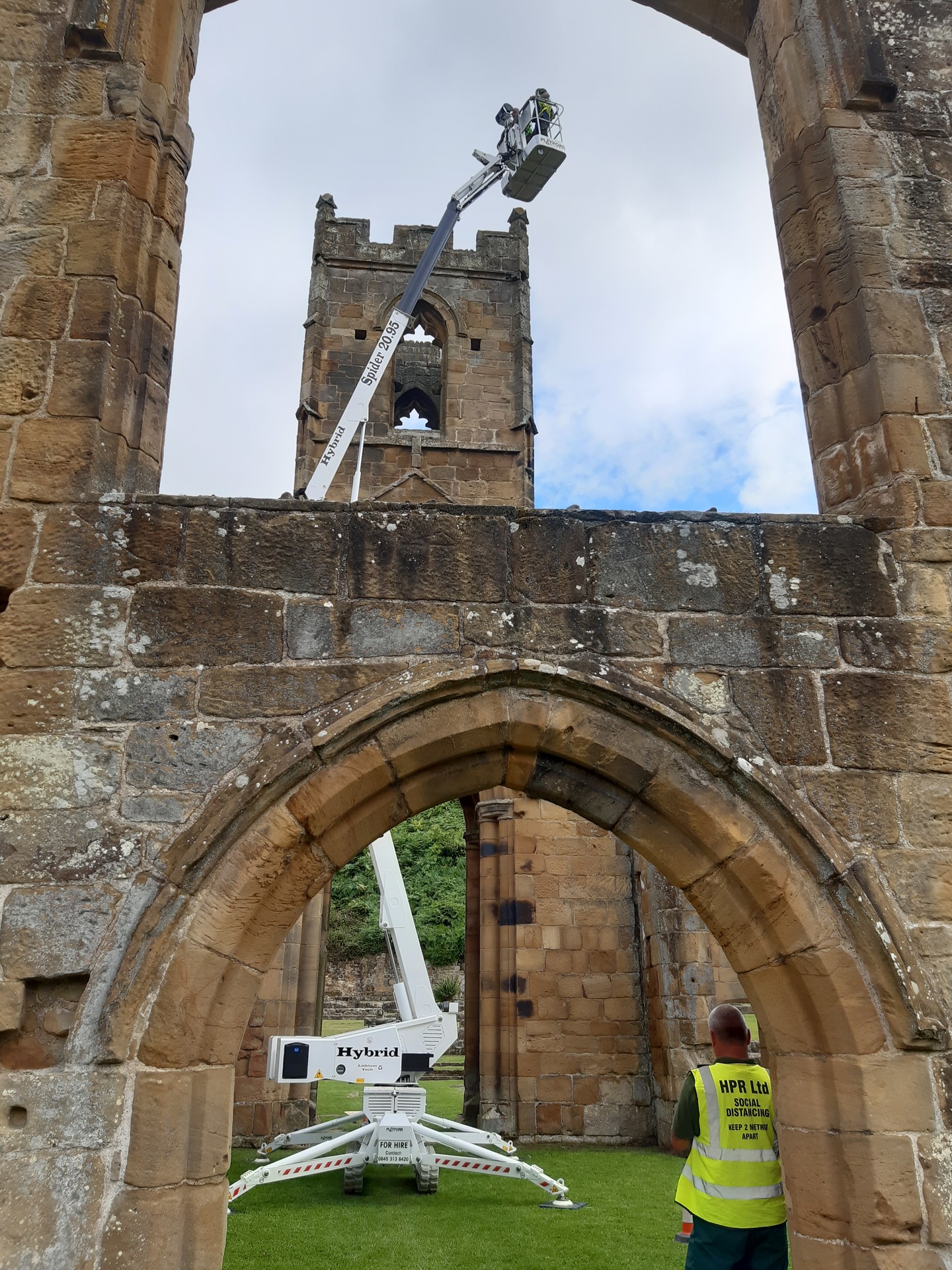 Lottie, High Reaching Solutions 20m Lithium hybrid tracked spider lift access platform at nearly full height assisting with a stone survey at a ruined abbey near Northallerton, North Yorkshire