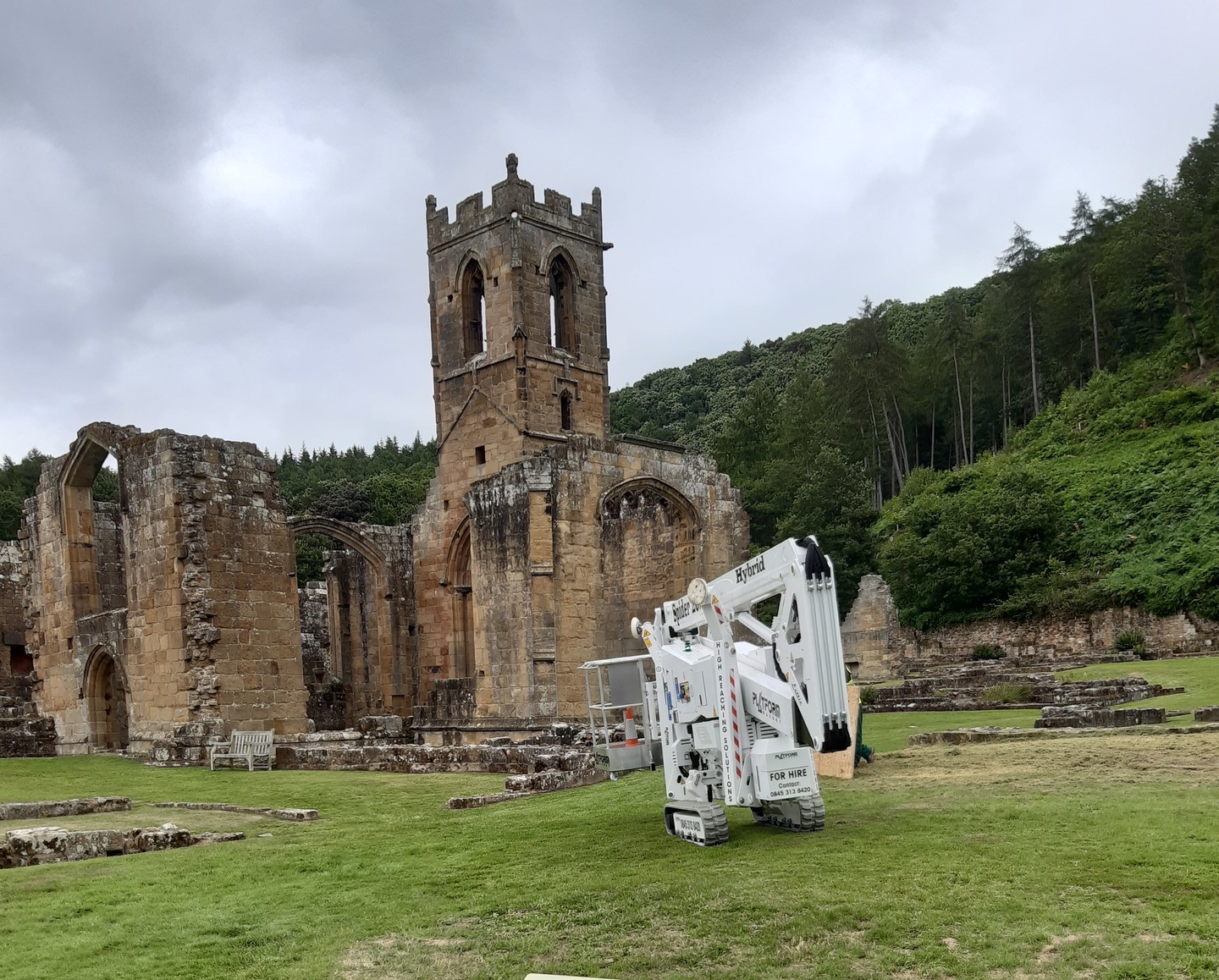 Lottie, High Reaching Solutions 20m Lithium hybrid tracked spiderlift leaving a ruined abbey after assisting with a stone survey near Northallerton, North Yorkshire.