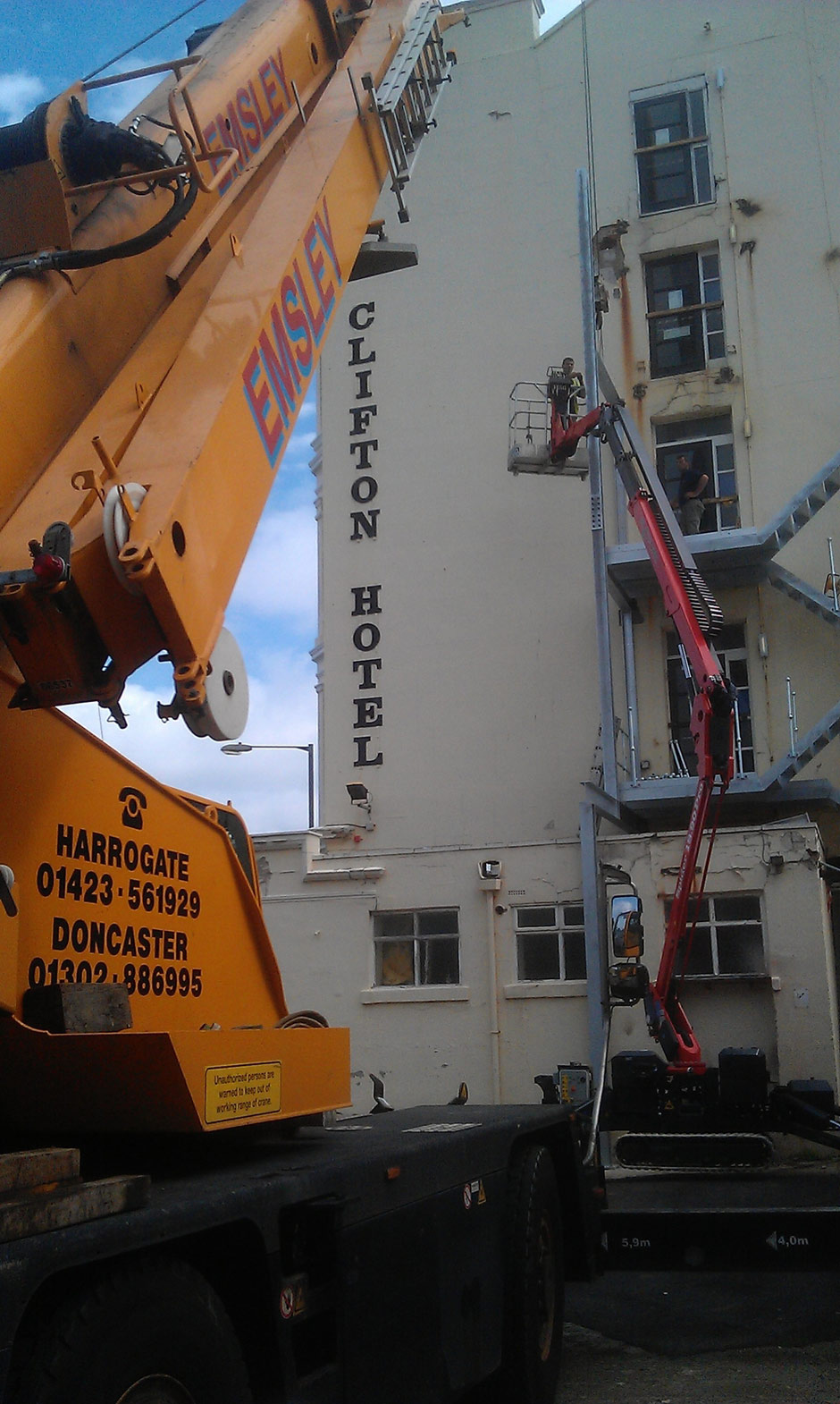 Sophie, tracked spiderlift cherrypicker from High Reaching Solutions installing new fire escape in Scarborough Malton York